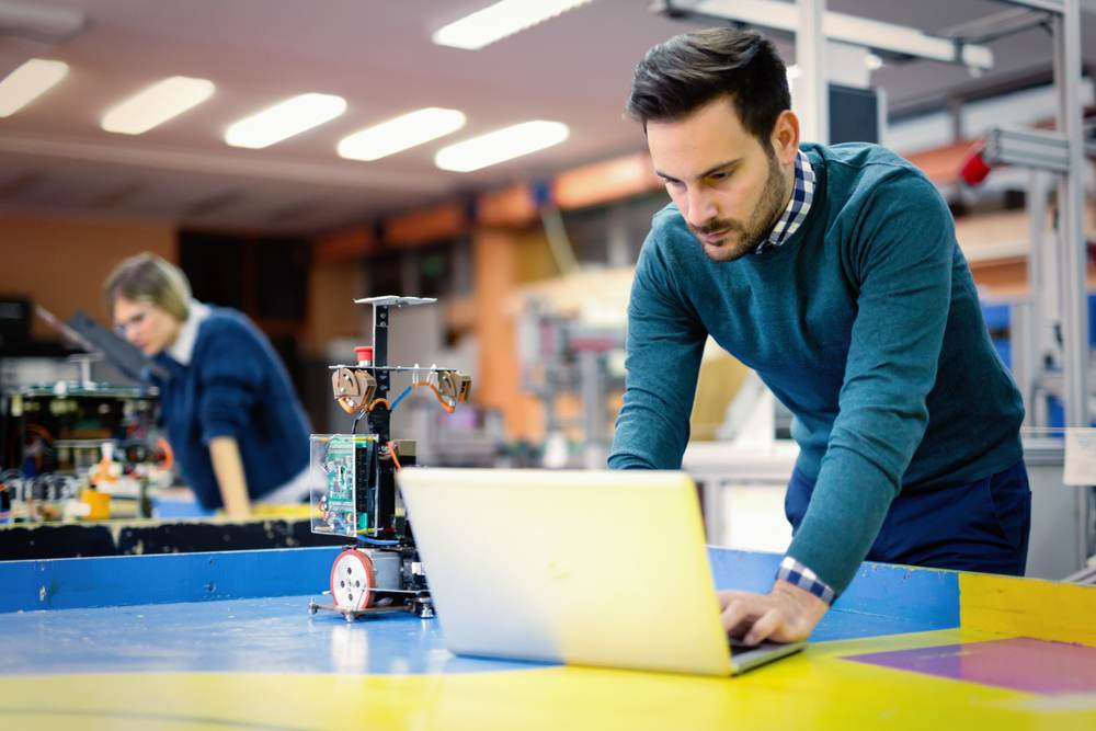 male student working on a project using his laptop
