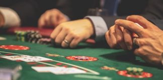 A picture containing room, gambling house, scene, person Description automatically generated