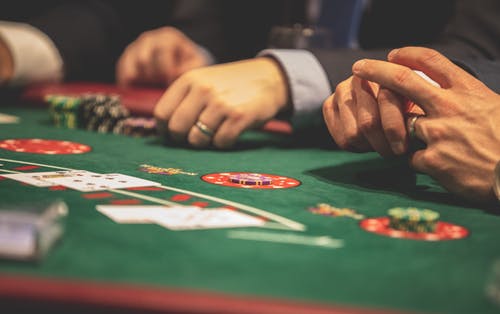 a-picture-containing-room-gambling-house-scene A picture containing room, gambling house, scene, person Description automatically generated