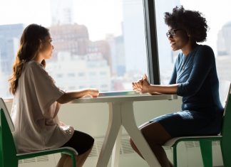 WHY DOES COMMUNICATION PLAY A PIVOTAL ROLE IN EVERY WALK OF LIFE? Two Women Sitting on Chairs Beside Window