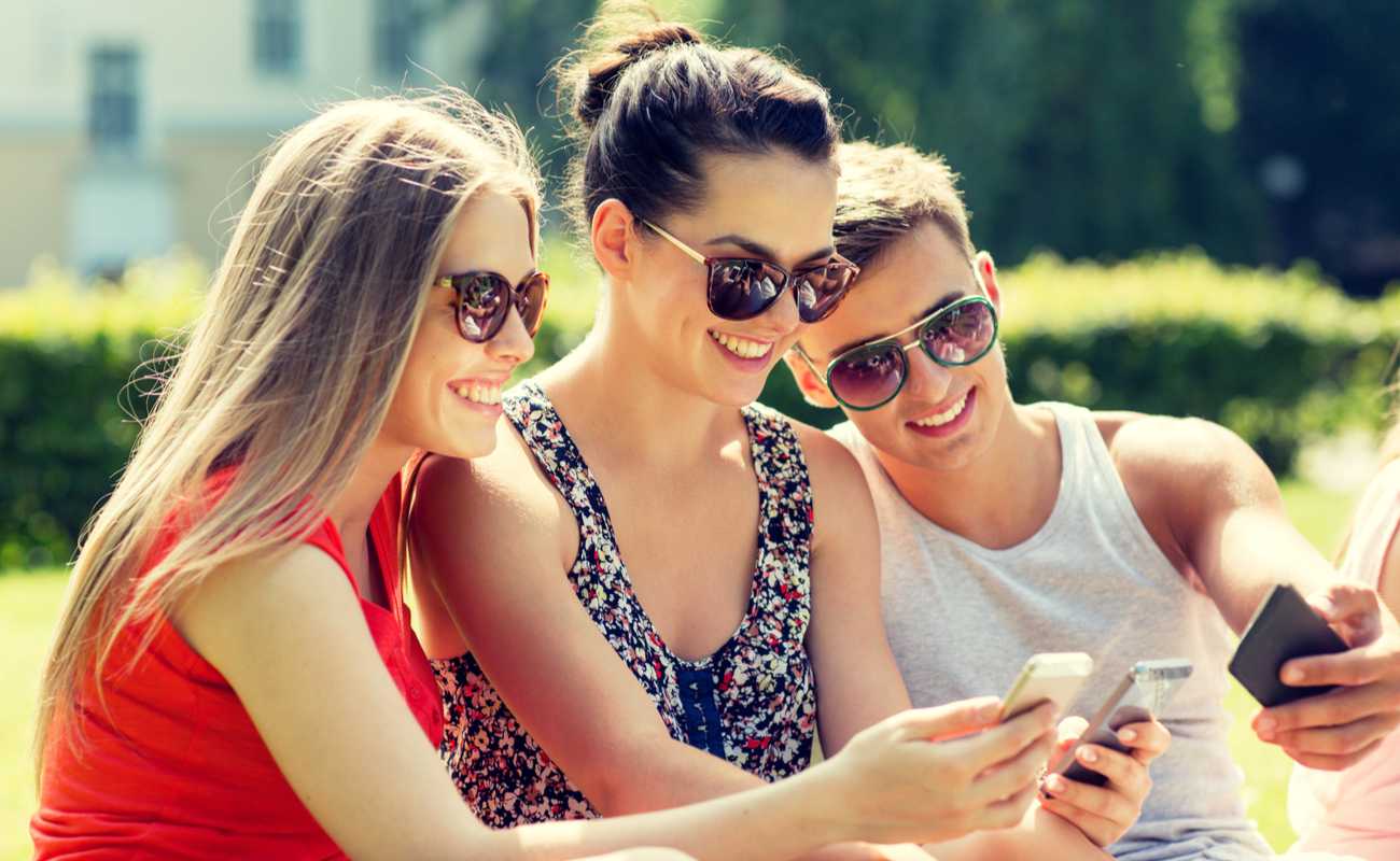 Friends taking a selfie with their smartphones