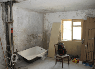 A picture containing indoor, floor, room, old Description automatically generated