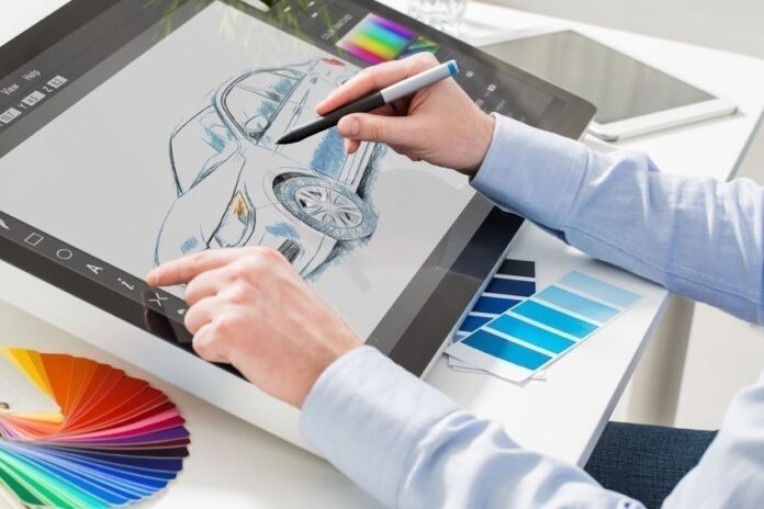 Graphic designer at work. Color samples. Una persona con una laptop Descripción generada automáticamente con confianza baja