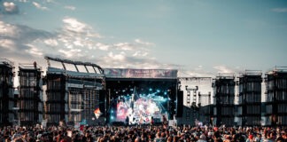 A large crowd of people at a concert Description automatically generated