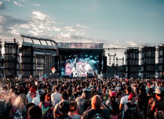 A large crowd of people at a concert Description automatically generated