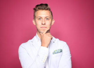 A person in a white coat Description automatically generated with medium confidence