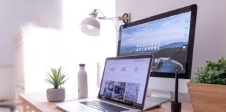 MacBook Pro on table beside white iMac and Magic Mouse