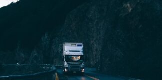 trailer truck passing on road near rail guard