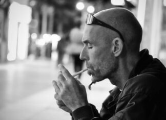 What are the Leading Causes of Hair Loss You Should Not Ignore? grayscale photo of man lighting cigarette