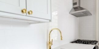 white wooden door beside stainless steel sink