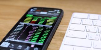 A cell phone next to a keyboard Description automatically generated with medium confidence