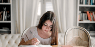 A person reading a book Description automatically generated with medium confidence