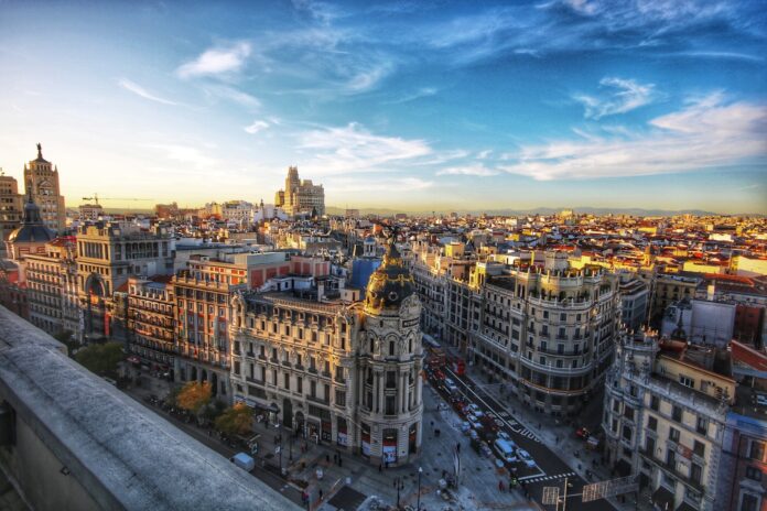 Photo by Jorge Fernández Salas city scale under blue sky