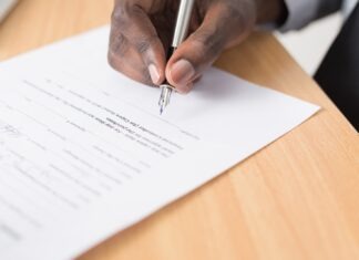 When Would an Individual Need a Solicitor? person writing on white paper