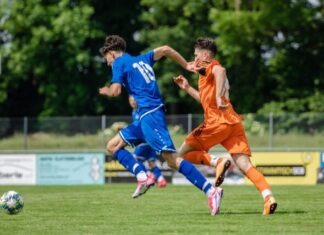 3 Reasons Why Soccer Gambling Is So Popular man in blue and orange jersey shirt running on green grass field during daytime