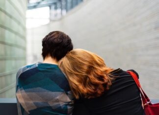 Rehab in Michigan: The Benefits of Finding Treatment a woman rests her head on another person's shoulder