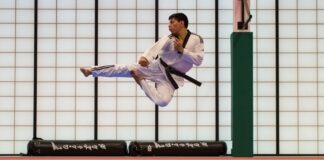 man doing karate stunts on gym