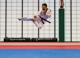 man doing karate stunts on gym