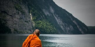 man sitting near ocean