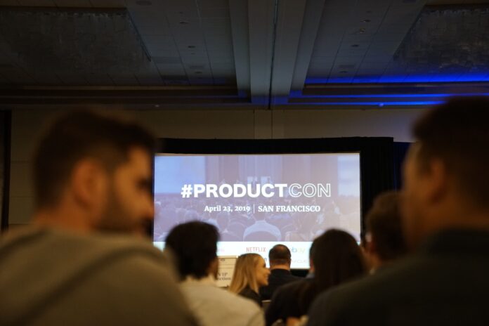 Photo by Product School people in conference with projector screen in front