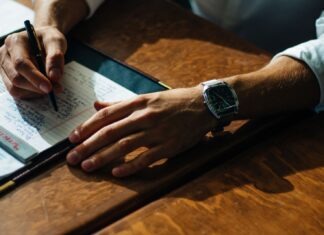 10 Effective Tips to Write an Essay in 30 Minutes person writing on paper leaning on brown table