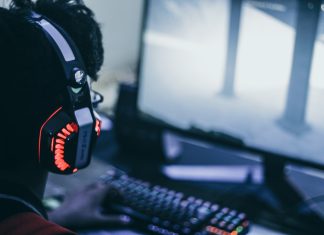 How to earn FFXIV Gil fast and make more money person wearing orange and black headphones