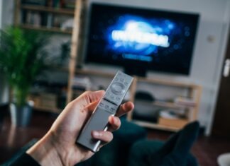Top 5 Action Movies To Watch Right Now person holding gray remote control