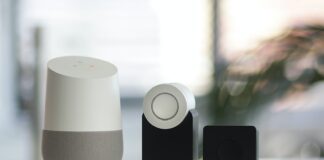 white and gray Google smart speaker and two black speakers