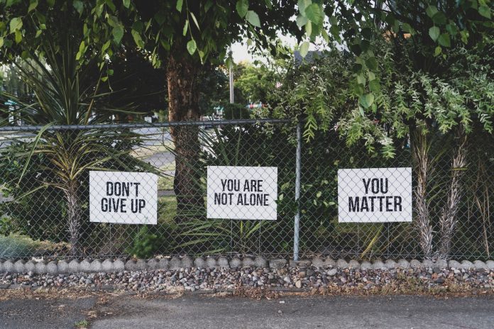 Photo by Dan Meyers don't give up. You are not alone, you matter signage on metal fence