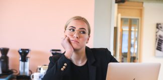 woman in black long sleeve shirt using macbook
