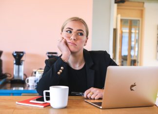 woman in black long sleeve shirt using macbook