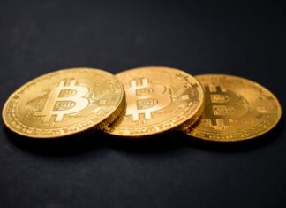 How Could Bitcoin Affect Servicenow and Other Companies? three gold-colored bitcoins on black surface