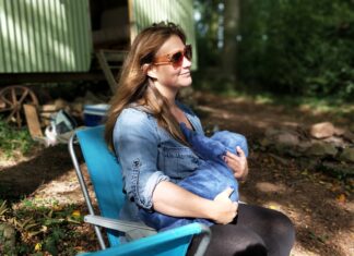 Breastfeeding Vs. Formula Feeding: Learn What The Best Is For Newborn Babies woman carrying baby while sitting on chair
