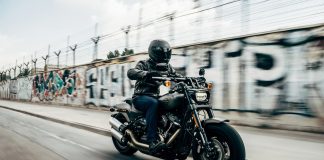 person riding motorcycle on concrete road