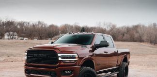 red chevrolet crew cab pickup truck on dirt road during daytime