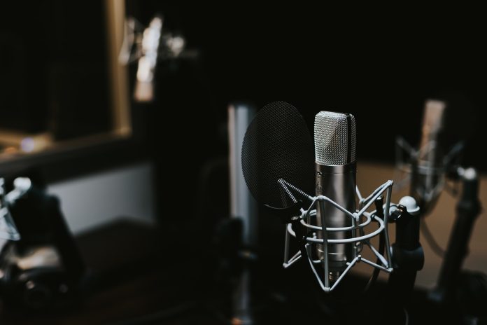 Photo by Jonathan Velasquez macro photography of silver and black studio microphone condenser