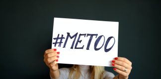 woman holding paper with metoo sign written
