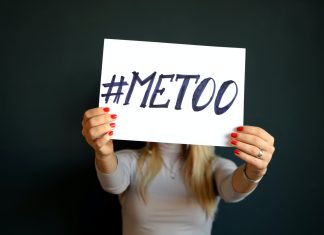 What Can You Do If You’ve Been Sexually Harassed at Work? woman holding paper with metoo sign written