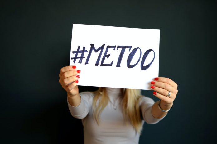 Photo by Mihai Surdu woman holding paper with metoo sign written