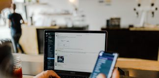 person using phone and laptop