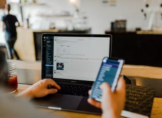 What Is Sender Reputation and Why Should You Care person using phone and laptop