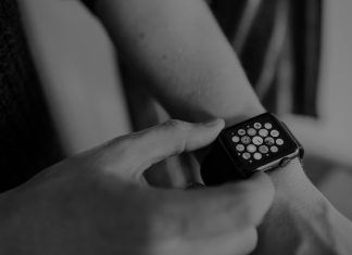 4 Best Apple Watch Bands for Women grayscale photo of person using Apple Watch