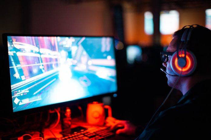person-using-computer-playing-fps-game person using computer playing FPS game