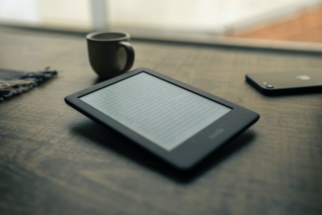Photo by @felipepelaquim black android smartphone beside black ceramic mug on brown wooden table