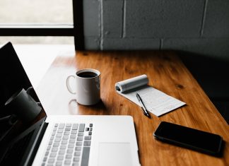 You Are the Quality Manager if You Like to Work From Home MacBook Pro, white ceramic mug,and black smartphone on table