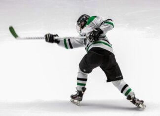 NHL History: The 5 Greatest Goalies in NHL Draft All Time man wearing green and white ice hockey jersey while playing
