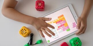 person holding white ipad on white table