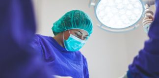 woman wears green face mask