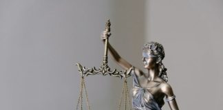 woman in dress holding sword figurine