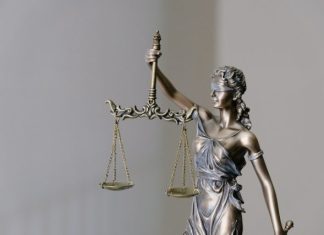 woman in dress holding sword figurine